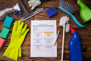 cleaner from Tidy Cleaning Champs following a standard cleaning checklist in a modern living room.