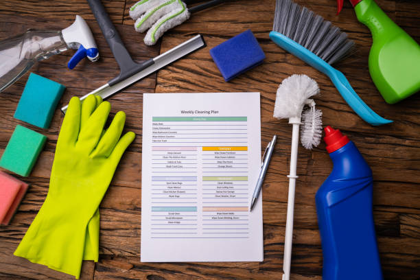 cleaner from Tidy Cleaning Champs following a standard cleaning checklist in a modern living room.