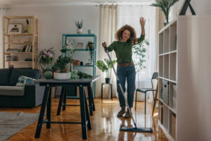 Cleaner removing hidden dust and dirt from a living room sofa and floor